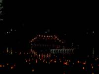 A boat among candles floating in the Danube